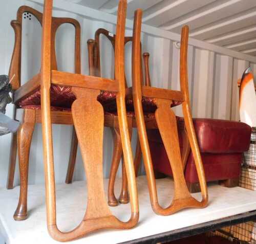Four Queen Anne style dining chairs, with drop in seats, raised on cabriole front supports, and...