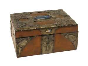 An early 20thC Arts & Crafts sewing box, the hinged lid overlaid with leather and pressed pewter...