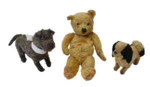 A group of early 20thC straw filled soft toys, comprising a blonde jointed Teddy bear, 39cm high,...