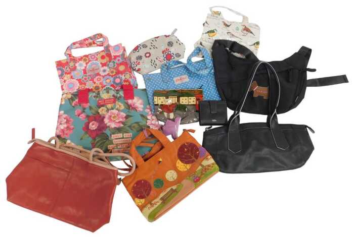A group of handbags, to include two Radley leather bags, one in black and the other in two tone...
