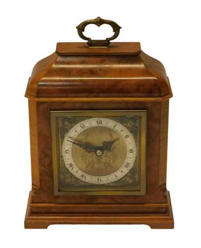An Elliott mantel clock, in a figured walnut case, with square brass dial and silvered chapter...