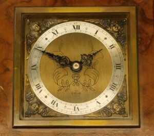 An Elliott mantel clock, in a figured walnut case, with square brass dial and silvered chapter... - 2