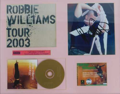 Robbie Williams interest. A framed display depicting a photographic print of Robbie Williams...