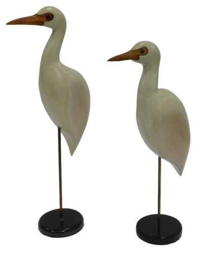 Two Feathers of Knysna hand painted and carved wooden cattle egret figures, each mounted on a...