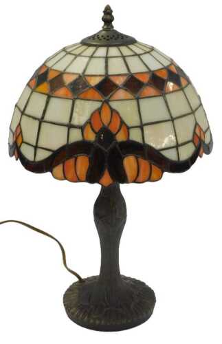 A 20thC Tiffany-style table lamp, the circular shade in an orange and milk-glass colourway,...