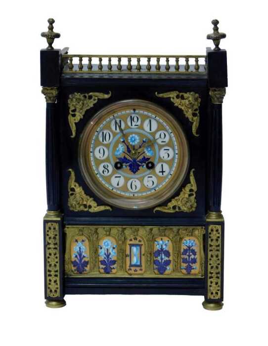 An early 20thC Aesthetic movement clock, in a Gothic Revival case, with painted enamel dial with...