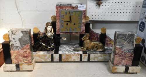 A French Art Deco marble clock and garniture, the square dial bearing Arabic numerals, with an...