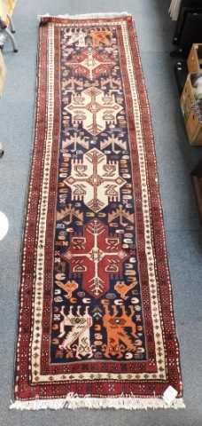 A Caucasian blue ground runner, with four central medallions and stylised beasts within multiple...