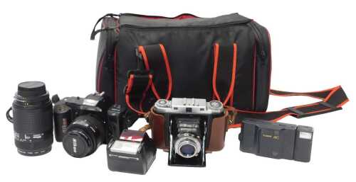 A group of cameras and optical-related equipment, to include a Nikon F-401 camera, with a...