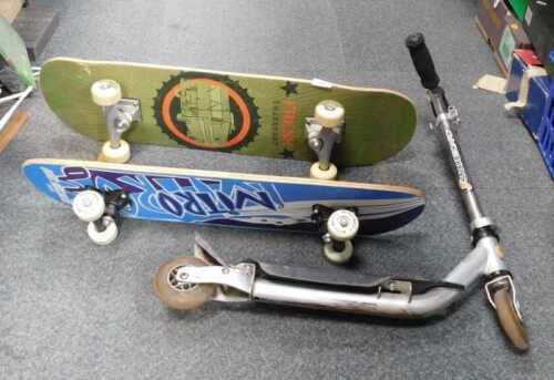 Two wooden based skateboards, and a metal scooter. (contents under 1 table)