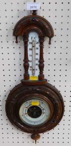 An oak carved wall barometer, with mercury measure, 52cm high.