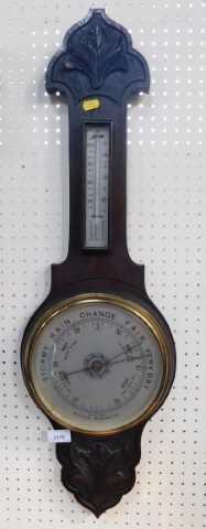 An oak carved drop dial aneroid barometer, with silvered dial and mercury measure, 77cm high.