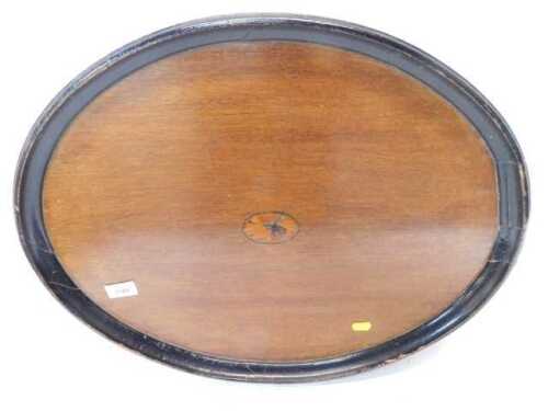 An Edwardian Sheraton Revival oak oval tray, with ebonised border and central inlaid rosette,...