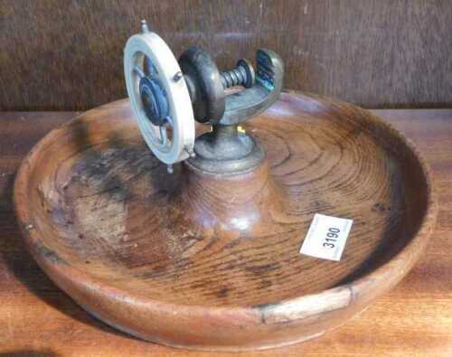 An oak ship's wheel mounted nutcracker.