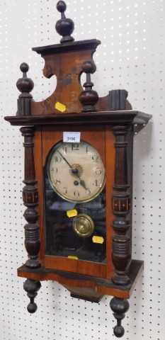 A walnut and oak cased wall clock, circular dial bearing Arabic numerals, with a thirty hour...