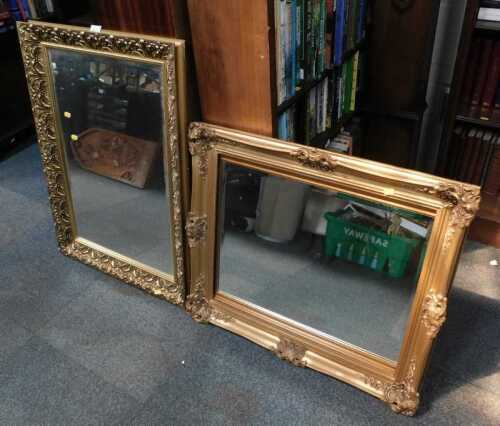 Two gilt framed wall mirrors, each in a carved surround, the largest 92cm x 64cm.