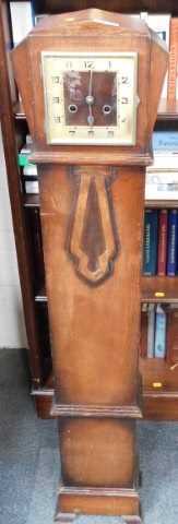 An oak cased grandmother clock, the square dial bearing Arabic numerals, with an eight day...