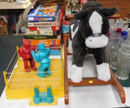 A plush rocking horse, and a stained wooden base, 60cm high, together with a Raving Bonkers...
