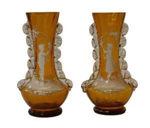 A pair of Victorian amber glass vases, with crimped glass ornamentation, and painted with Mary...