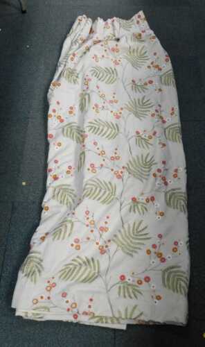 A single lined door curtain, of floral design, drop 182cm, 246cm wide.