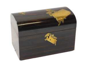 A Victorian coromandel tea caddy, of plain dome chest shaped design, the hinged lid with...