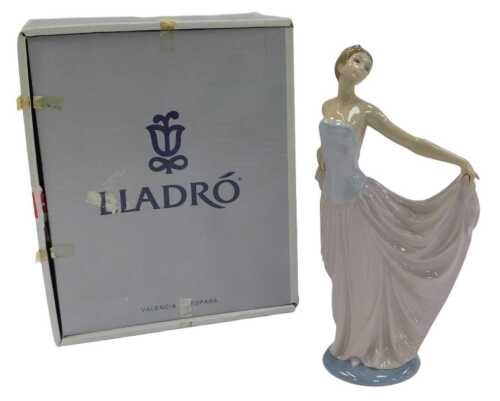 A Lladro porcelain figure, modelled as a lady wearing an evening gown, 29cm high, boxed.