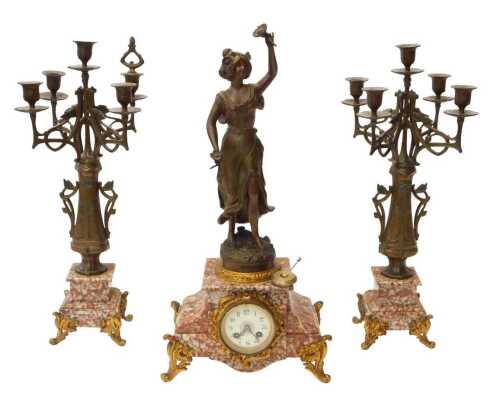 A late 19thC French three-piece figural clock garniture set, within a rouge marble case having...