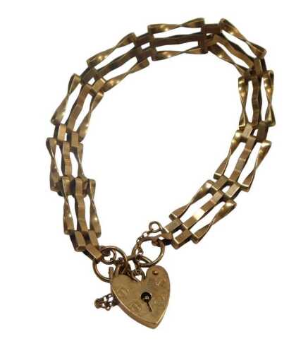 A 9ct gold three bar gate bracelet, with safety chain and heart shaped padlock, 16cm long, 7.8g.