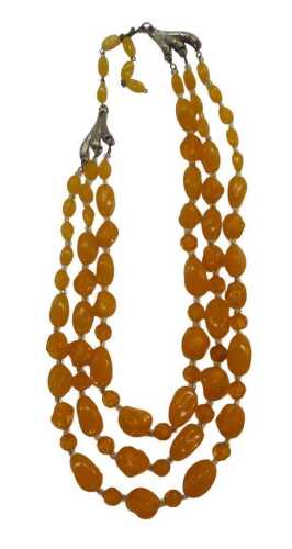 A three row imitation amber necklace, with butterscotch and clear coloured beads, of graduated...