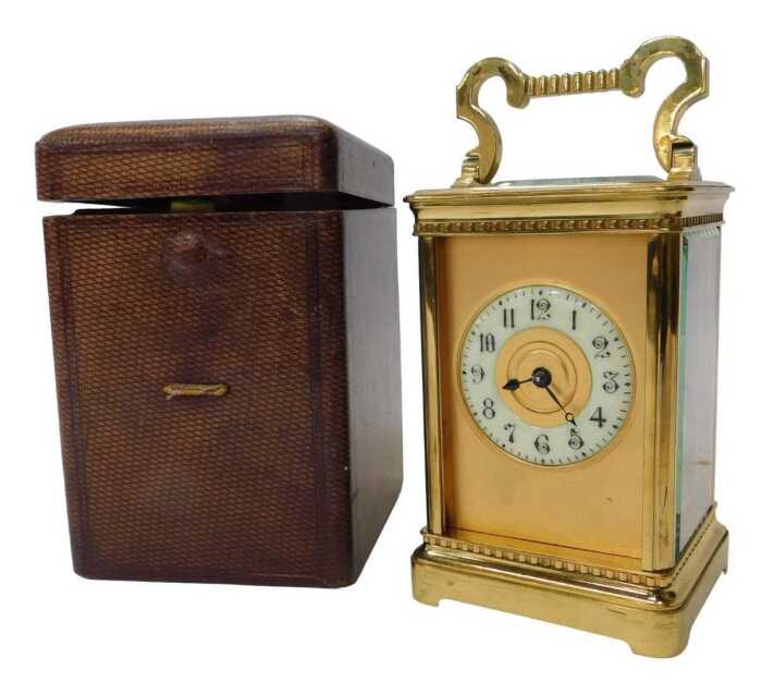 An early 20thC brass cased carriage clock, with an ivory porcelain dial having Arabic numerals,...