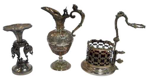 A group of late 19thC silver plate and metalware, comprising a pierced wine bottle stand, with a...