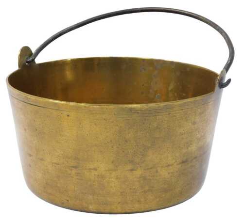 A late 19thC brass jam pan, with a cast iron swing handle, 31.5cm high.