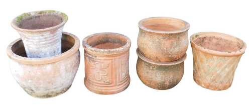 A group of terracotta plant pots, each of differing design, to include a pair of cylindrical...