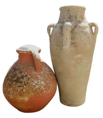 A terracotta amphora style garden planter, of cylindrical tapering form, with four ring handles,...