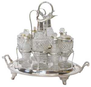 A George III silver cruet stand, the central handle decorated with a lower band of leaves, on...