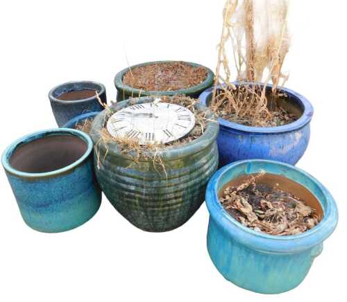 A group of terracotta and stoneware blue and green glaze plant pots, to include a green drip...