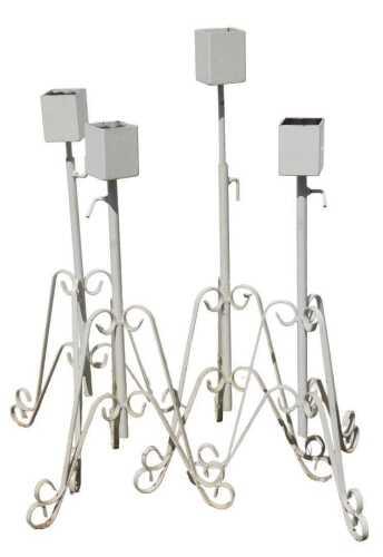 Four painted wrought metal garden plant stands, with adjustable height.