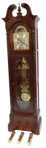 A Howard Miller mahogany cased longcase clock, the brass break arch dial with foliate spandrels,...