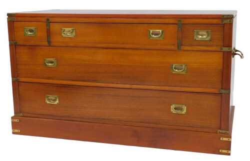 A late 20thC teak campaign chest, with one medium flanked by two short drawers, over two long...