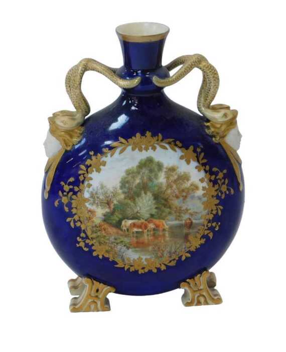 A 19thC Coalport style porcelain moon flask vase, with serpentine handles and mask heads, and a...