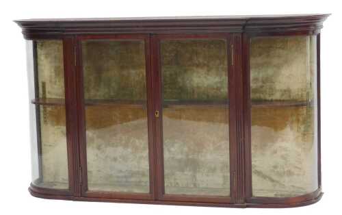 A late Victorian mahogany bow front wall hanging display cabinet, with an outswept pediment over...