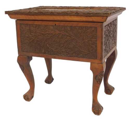 An early 20thC Anglo Indian carved hardwood sewing box, decorated with flowers and scrolling...