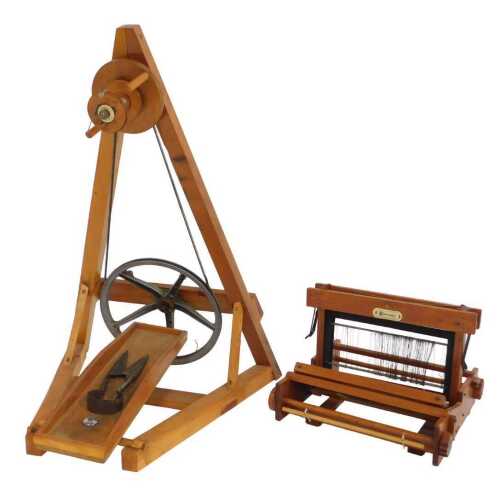 A 20thC Wearmaster pine spinning wheel, 95cm high, 107cm deep, with a pair of cast iron sheep...