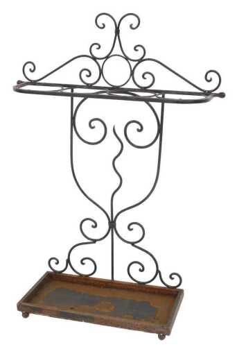 An early 20thC cast and wrought iron umbrella and stick stand, with a rectangular drip tray...