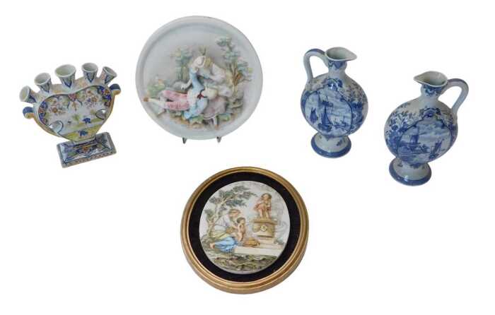 A pair of Delft blue and white transfer printed ewers, decorated with scenes of shipping and...