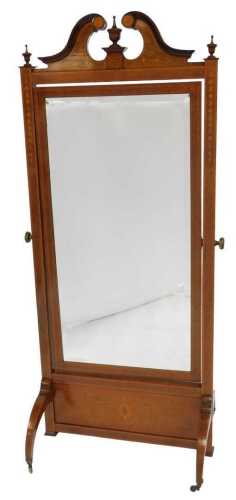 An Edwardian Sheraton Revival cheval mirror, with satinwood crossbanding and inlay of flowers, scrolling leaves, and harebells, the break arch pediment centred on an urn, flanked by two further urns, above a swing frame mirror, set with rectangular bevell