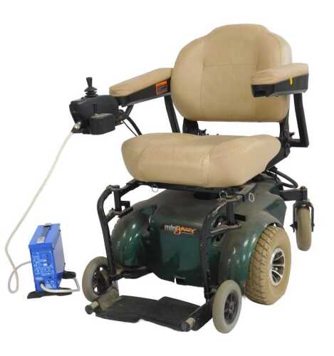 A Pride Mini Jazzy mobility scooter, with a cream leather seat and back, and a green chassis,...