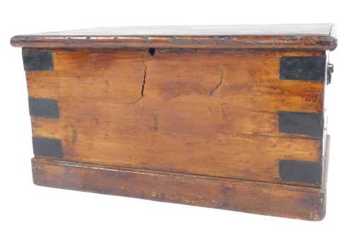 An early 20thC stained pine carpenter's toolchest, the hinged lid opening to reveal various...