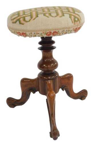 A Victorian rosewood revolving piano stool, with a woolwork upholstered circular seat, raised on...