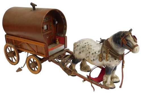 A Romany Rose gypsy wooden caravan, pulled by a pottery dappled shire horse, the cart with...